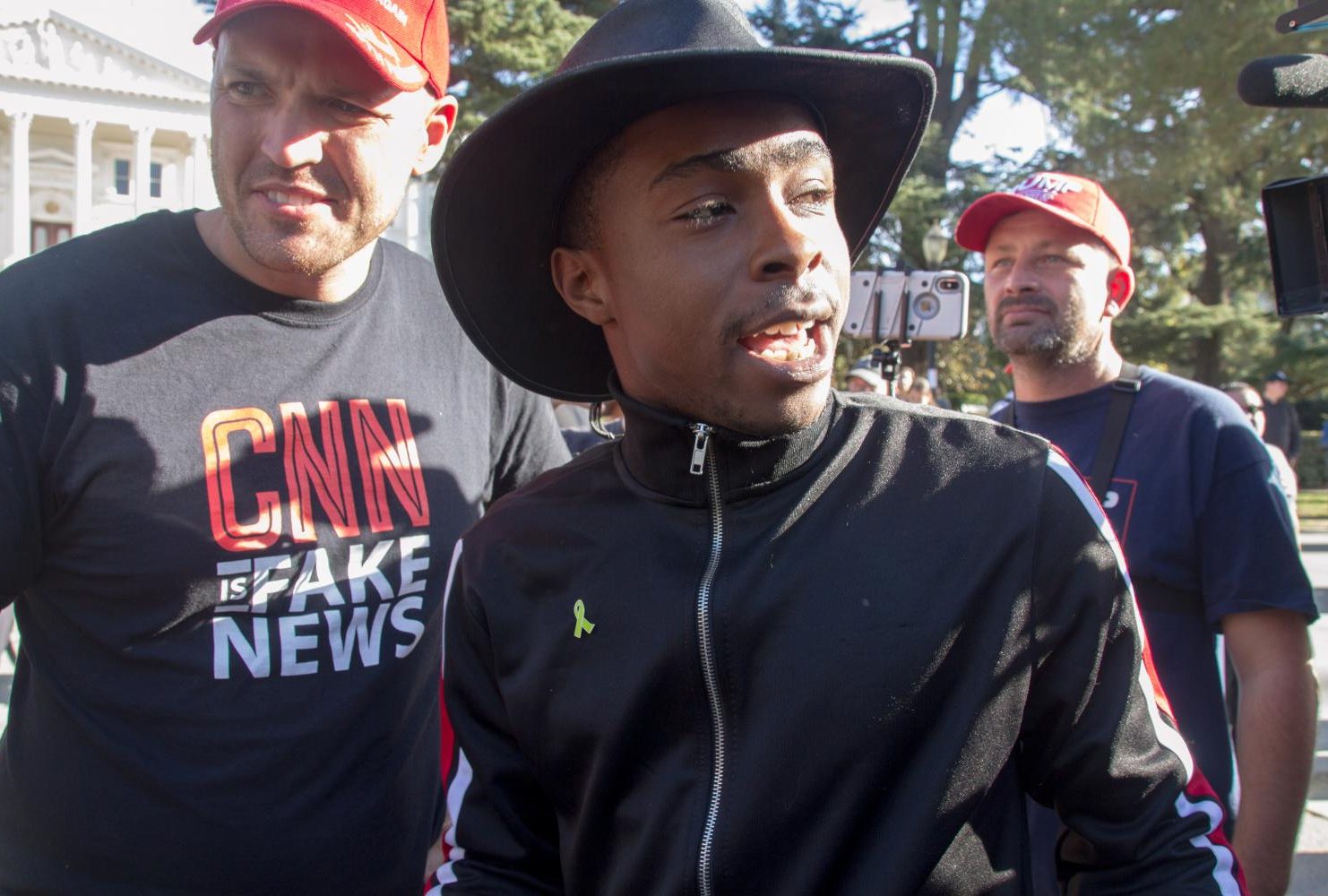 Stevante Clark, who gained notoriety in March 2018 while protesting the shooting of his brother Stephon Clark, speaks to “Turn California Red” conservative rally organizer Ben Bergquam at the California State Capitol on Nov. 4, 2018. (Photo by Patrick Hyun Wilson)