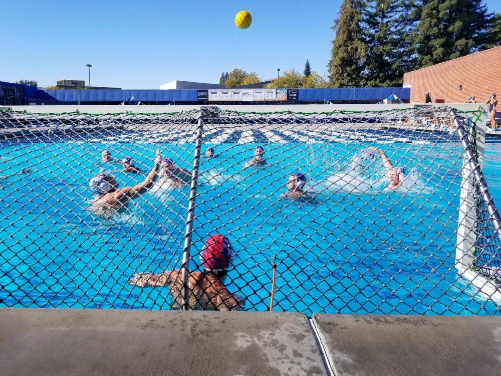 Students in mens water polo practice scoring goals in American River Colleges pool by the gym on Nov. 7, 2018. (Photo by Hannah Yates)
