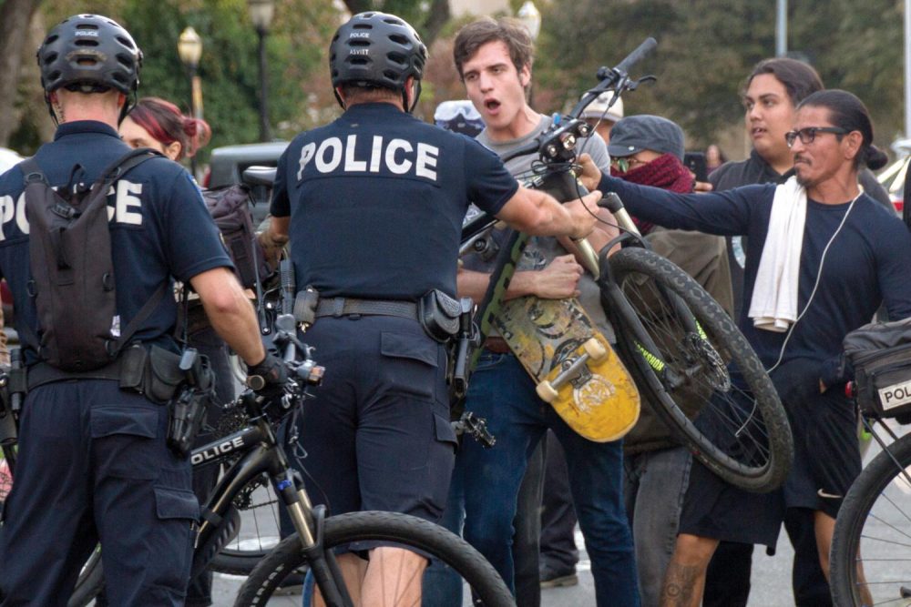 Sacramento Police use their bikes to push counter-protestors off the street during a “Turn California Red” conservative rally at the California State Capital on Nov. 4, 2018. (Photo by Patrick Hyun Wilson)