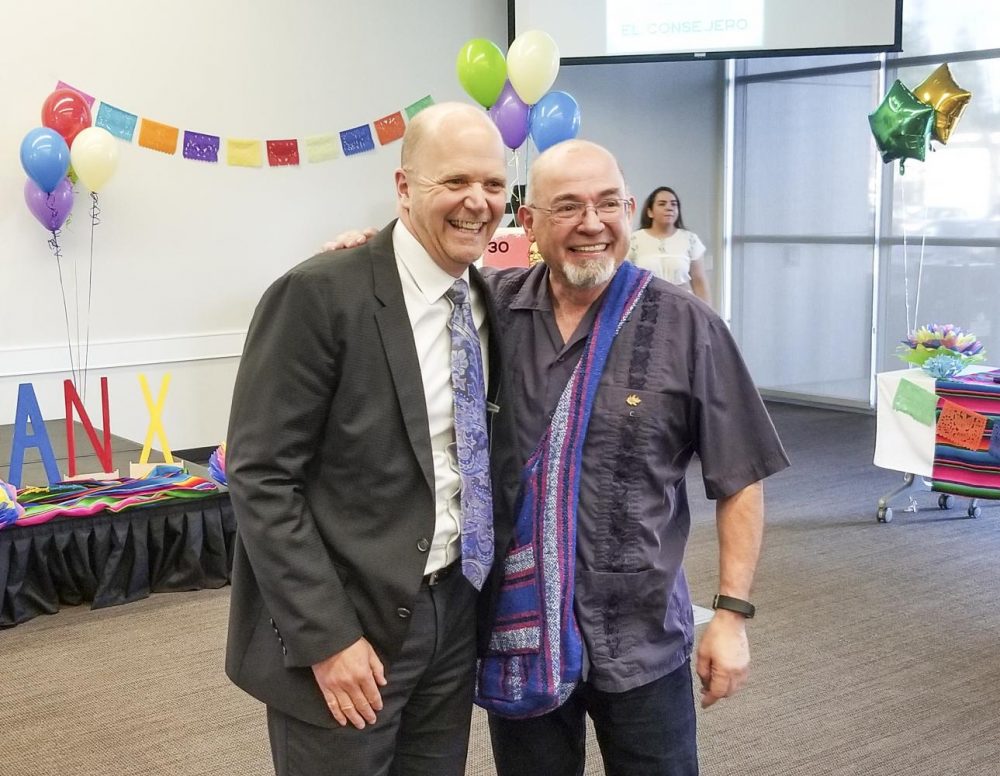 Thomas Greene, President of American River College (left), congratulates Manuel Ruedas, Puente Project coordinator and Trio (STEM) counselor (right), at his retirement ceremony on Nov. 30, 2018 in the Community Rooms at American River College. (Photo by Christian Sutton) 