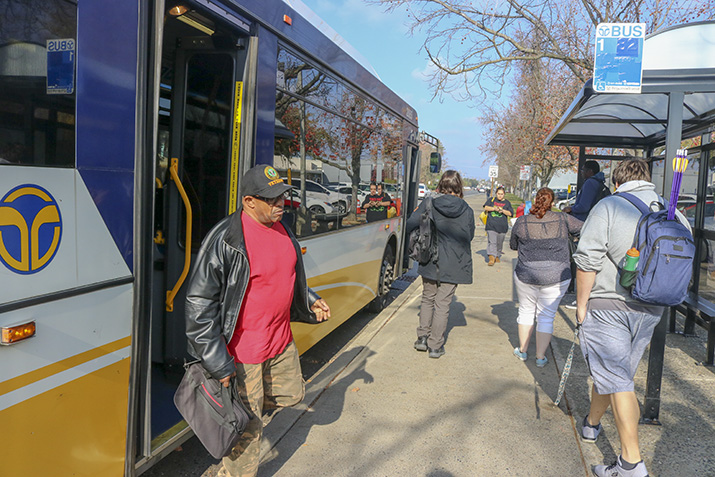 Students commute by bus to arrive at American River College while some leave campus on Dec. 11, 2018. Using public transportation is one of the many ways to help reduce emissions. (Photo by Hameed Zargry)
