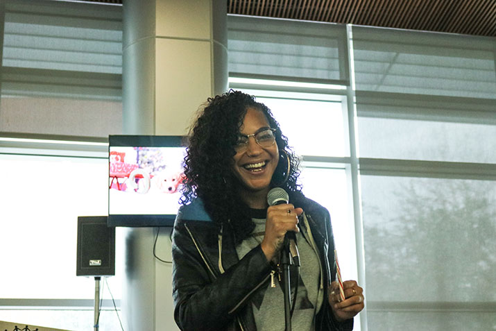 Grace Deyanna takes a break from hosting to recite her poem, “Newsworthy” at Tell it Tuesday in the Student Center on December 4, 2018. (Photo By Felix Oliveros)