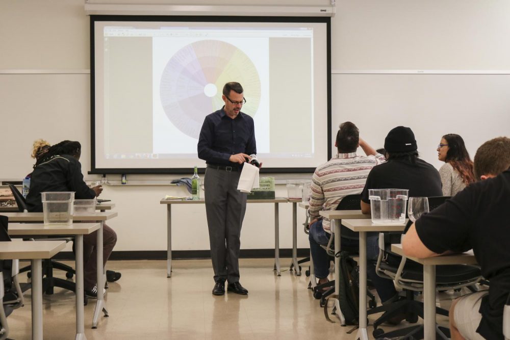 Professor Brian Knirk discussing the wines they are tasting in his Hospitality Management class at American River College Nov. 5, 2018. (Photo by Hannah Yates)