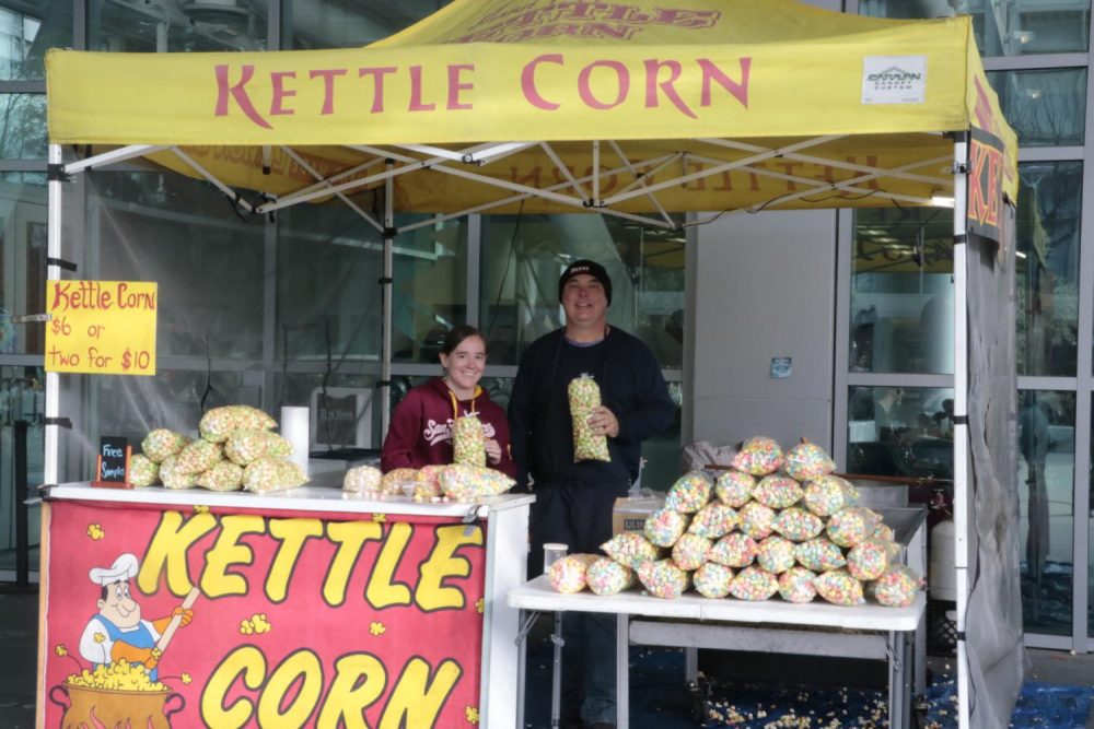Psychology major Karistianna Heiman and owner Adam Baker sell kettle corn outside the Student Center at American River College. (Photo by Gabe Carlos)