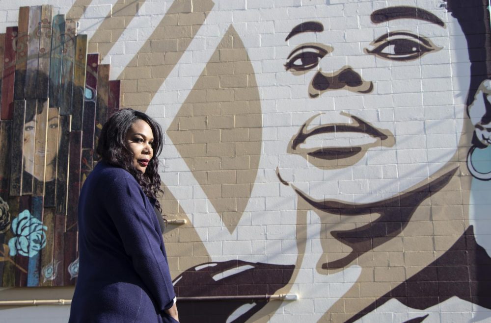 Activist Ebony Harper stands in front of the mural that she helped fund behind the Lavender Library in Sacramento, Calif. on Nov. 30, 2018. (Photo by Ashley Hayes-Stone)