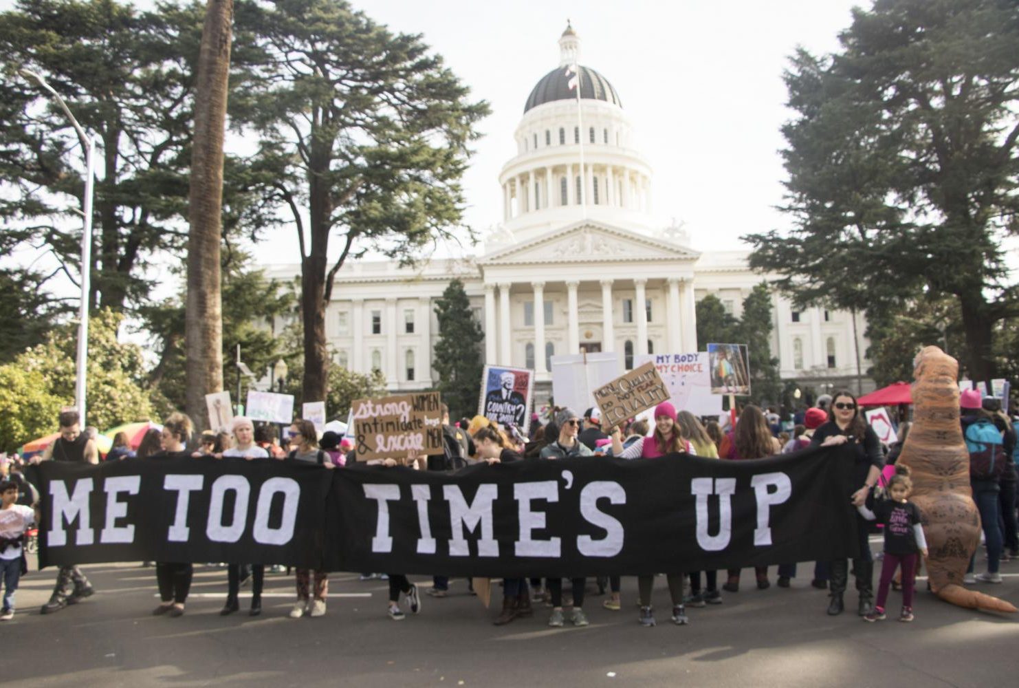 Demostrators hold up a banner that reads “Me Too Time’s Up in front of the California State Capitol during the third annual Women’s March in Sacramento, Calif. on Jan. 19, 2019. The number of attendance decrease from last year’s event according to Sacramento Police 10,000 individuals participated in the march than the  estimasted 36,000 marchers that attended last year.