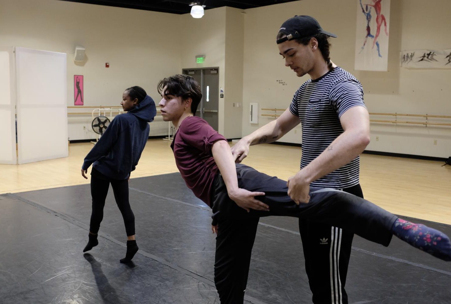 Dance major José-Antonio Gomez practices his posing with the help of Is Foss in the American River College dance studio on Feb. 6, 2019. (Photo by Patrick Hyun Wilson)
