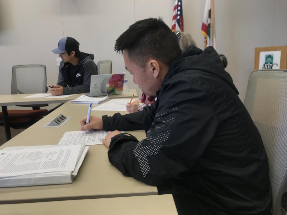 Director of Finance Dallas Vue adds notes to his agenda sheet at the Associated Student Body meeting at American River College on Feb. 22, 2019. (Photo by Alexis Warren)