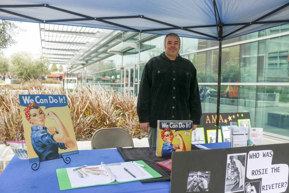 Art new media major Anthony Barbaria represents the Marketing Club and educates people on Rosie the Riveter on Club Day by the Student Center at American River College on March 7, 2019. (Photo by Alexis Warren) 