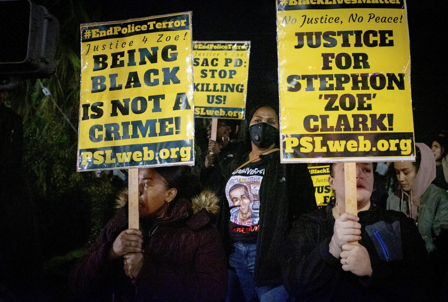 Demonstrators gather on the corner of Florin Road and 29th Street to protest the decision by the Sacramento County District Attorney’s Office to not press charges against the two police officers who shot and killed Stephon Clark last year. (Photo by Patrick Hyun Wilson)