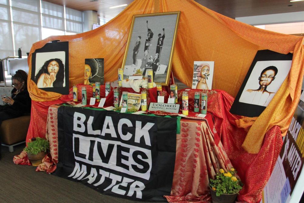 A table adorned with candles, a Black Lives Matter flag, and messages acknowledging and celebrating the lives of black Americans is set up in the Student Center. (Photo by Katia Esguerra)