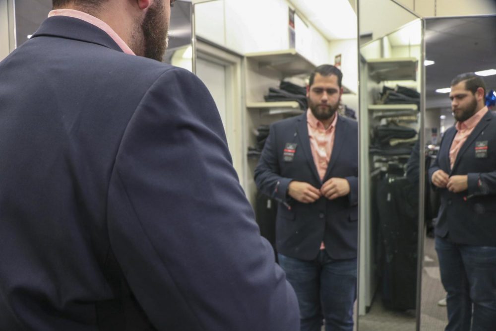 Engineering major Francisco Leon-Gomez tries on a suit during the first Suit Up Event, hosted by American River Colleges Career And Pathways Support Services on March 10, 2019. (File Photo)