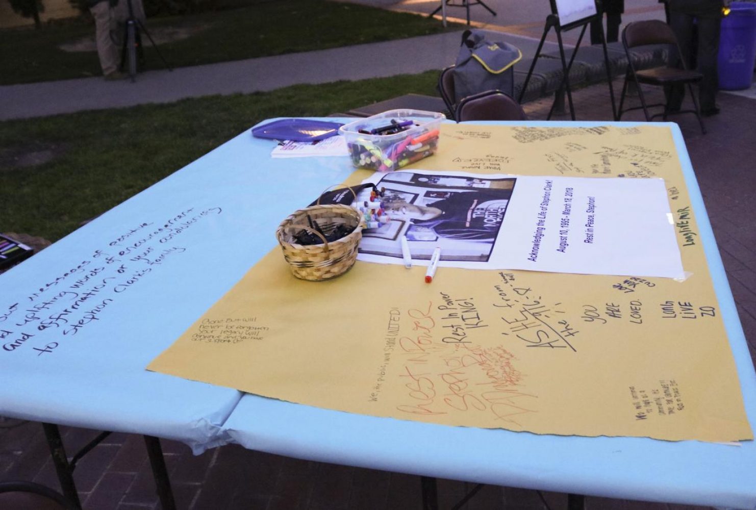 A poster bearing a photo of Stephon Clark’s face is covered in messages written by attendees of the vigil in front of the Performing Arts Center at Sacramento City College on March 7, 2019. Clark was a former Sac City College student. (Photo by Hannah Yates)