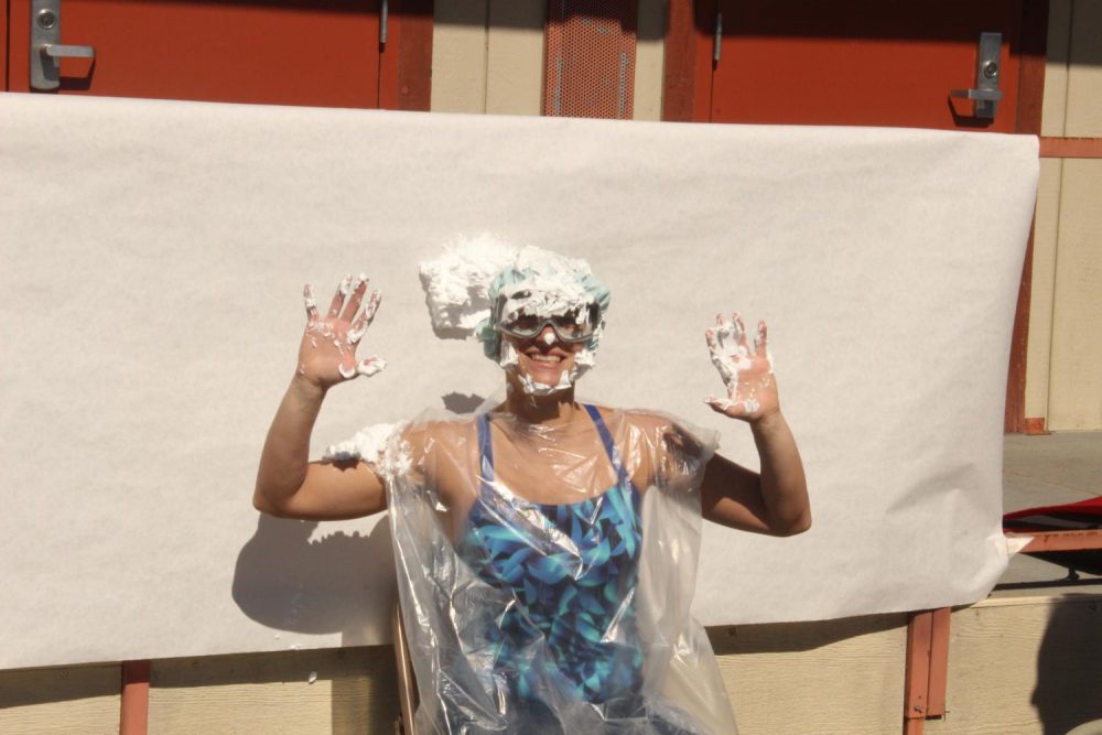 Mathematics assistant professor Helene Nehrebecki takes a pie to the face in honor of a Pi Day event hosted by the STEM Center, where students have the opportunity to throw pies at Nehrebecki and other professors at American River College to celebrate the never-ending constant used to find a circle’s circumference on March 14, 2019. (Photo by Thomas Cathey)