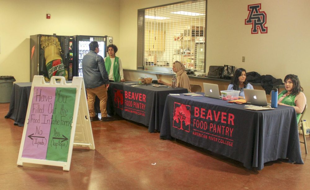 A sign that reads “Have you Filled Out the Food Intake Form?” directs students on which table to go to when they visit the Beaver Food Pantry in the gym at American River College on March 27, 2019. (Photo by Emily Mello)