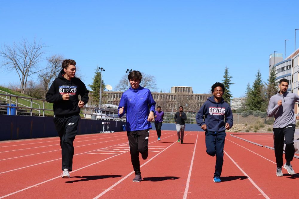 (From left to right) Runners Ricky Frank, Charles Pierce, Jordan Taylor and Zavier Beevers warming up at the start of practice. (Photo Illustration By Thomas Cathey)