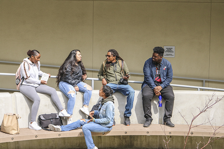 Umoja Sahku students, (From left to right) Mahogany McFarland, Kayla Sepulveda, Haven Bishop, Denzel Phoenix, and Sushiela King, all  hang out and connect between classes near the community rooms at American River College on March 19, 2019. (Photo by Breawna Maynard)