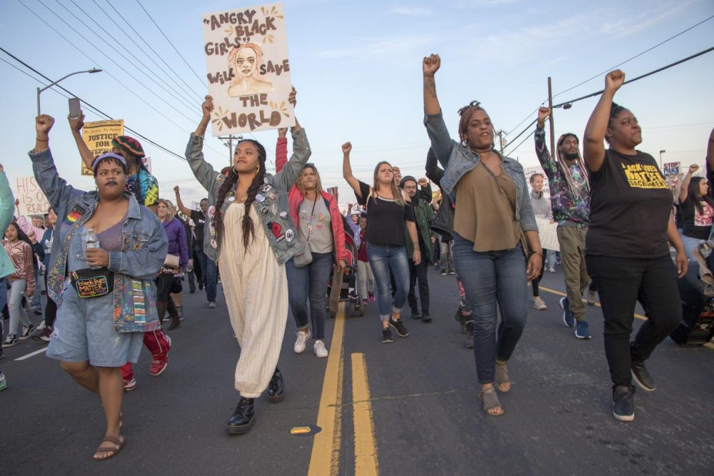 Black Lives Matter Sacramento demonstrators hold their fists in the air as they march down Meadowview Road during the one year anniversary of Stephon Clark’s death in South Sacramento, Calif. on March 18, 2019. (Photo by Ashley Hayes-Stone)
