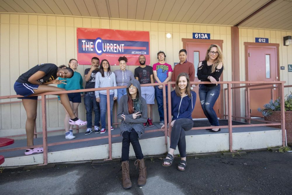 The American River College Current staff poses in front of a new banner outside of the newsroom on March 21, 2019. (Photo by Imani Smith)