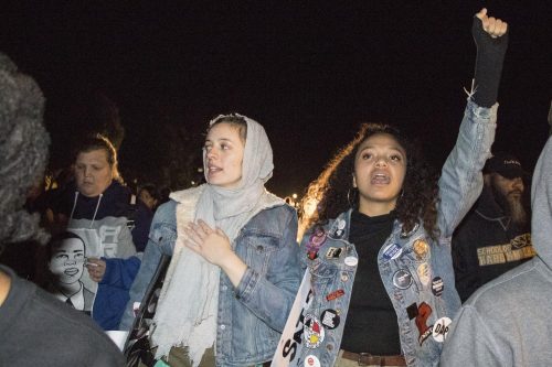 American River College U.N.I.T.E members Raven Kauba (left) and Dronme Davis (right) participate in a Stephon Clark protest on March 8, 2019. The two students were two of the 84 demonstrators who were arrested by Sacramento police officers during a Stephon Clark protest in East Sacramento on March 4, 2019. (Photo by Ashley Hayes-Stone)