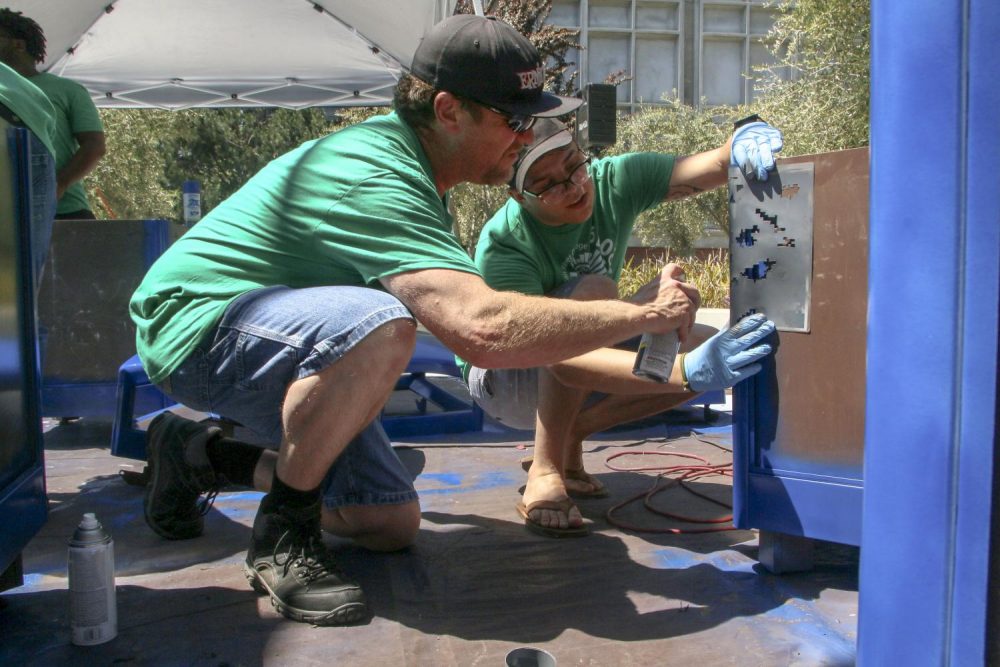 Association of Student Veterans President Brad Lavin (left) and Chief Information Officer Spencer Barnes (right) touch up the campus trash bins in the quad at  ARC for Earth Day, in collaboration with the Art Department on April 24, 2019. (Photo by Irene Jacobs)