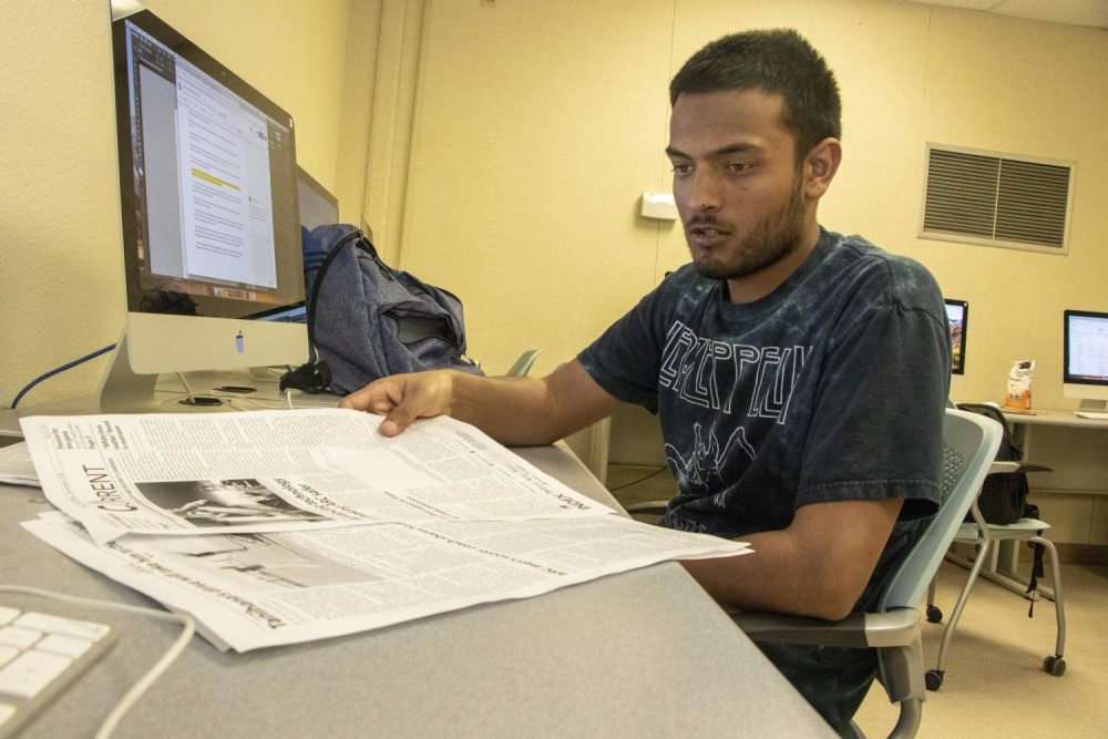 Gabe Carlos, sports editor of the American River Current, views proof pages of the upcoming print issue on April 8, 2019. The newspaper will come out this week on April 10th. (Photo by Ashley Hayes-Stone)