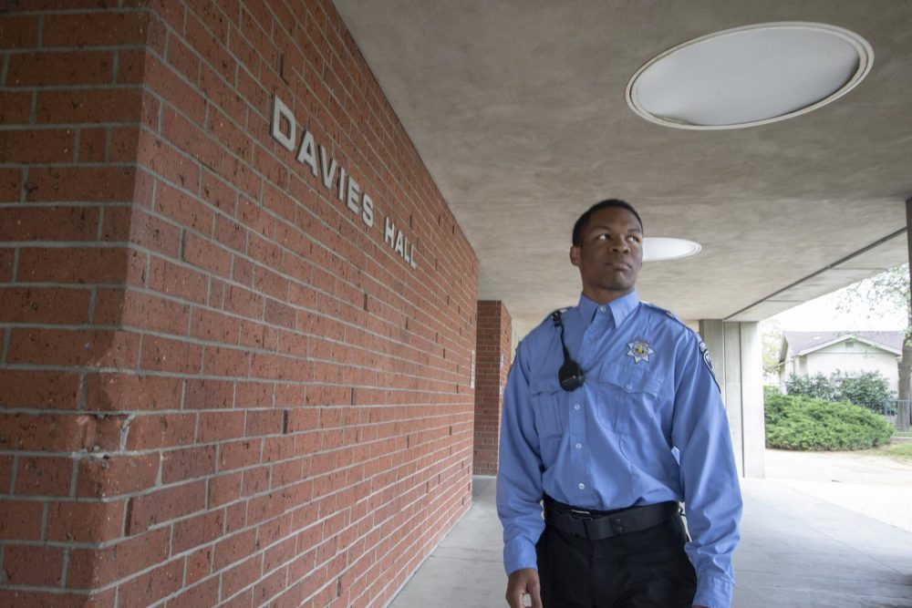 Campus patrol officer Joshua Harris walks the perimeter of Davies Hall to ensure the safety of the campus at American River College on April 3, 2019. (Photo illustration by Ashley Hayes-Stone)