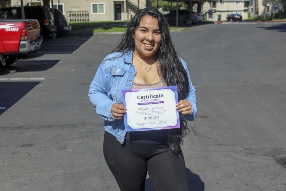 Kayla Sepulveda, criminal justice major, holds her scholarship certificate granted from the Los Rios Community District and the Pride Center at ARC on May 7, 2019. (Photo by Breawna Maynard)