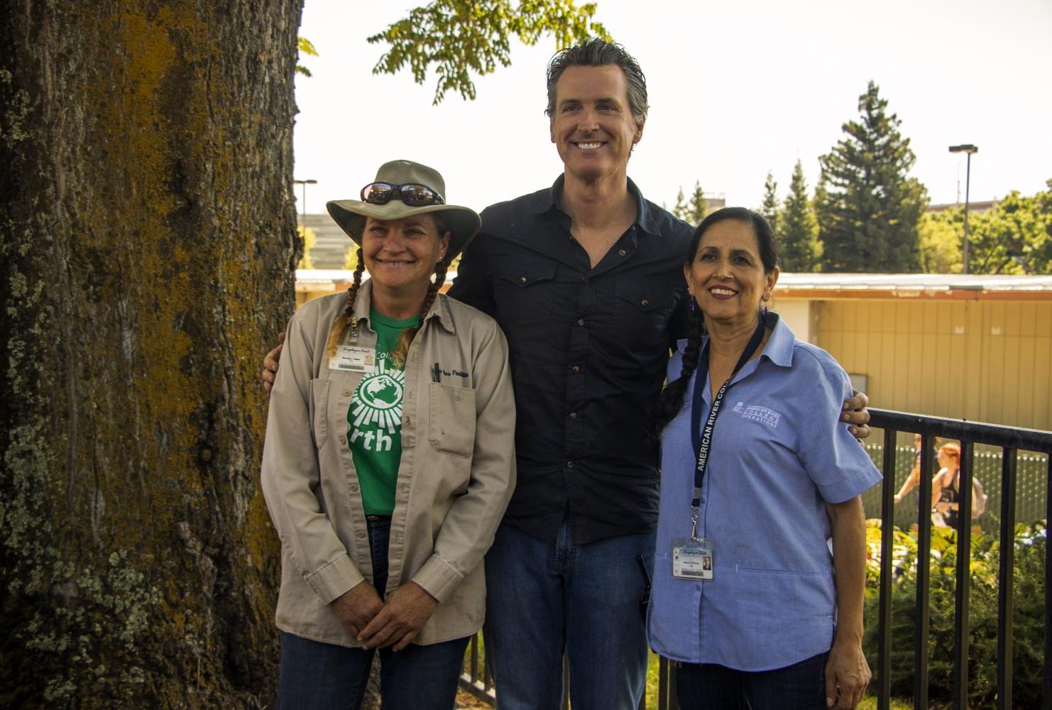 Governor Gavin Christopher Newsom poses with Brenda Baker (left) and Maria Arambula (right) after job shadowing them during International Workers’ Day at American River College on May 1, 2019. (Photo by Ashley Hayes-Stone) Download Permiss