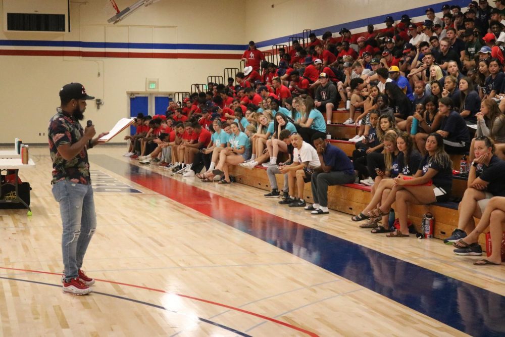 Kelvin Burt, instructional assistant for the Dusty Baker Center at American River College, reads off last year’s accomplishments of ARC’s student athletes at the main gymnasium at ARC on Aug. 30, 2019. (Photo by Thomas Cathey). 
