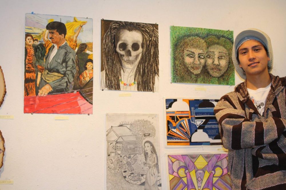 Art New Media student Miguel Gonzalez-Miranda, pictured here standing next to his works at the James Kaneko art Gallery at American River College in 2014, was detained by Immigration and Customs Enforcement agents on June, 2019. (File Photo)  