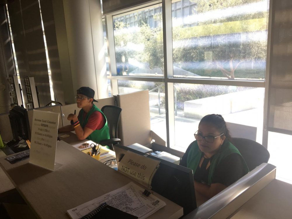 Sages Marlon Romero (left) and Itzin Alpizar (right) help people get their student IDs in the Student Center at American River College on Sept. 4, 2019. (Photo by Joshua Ghiorso)