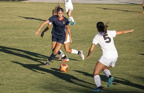 Forward Ashley Davis evades a defender in a game against Fresno City College on Sept. 6, 2019. American River College lost the match 4-0. (Photo by Colin Bartley)
