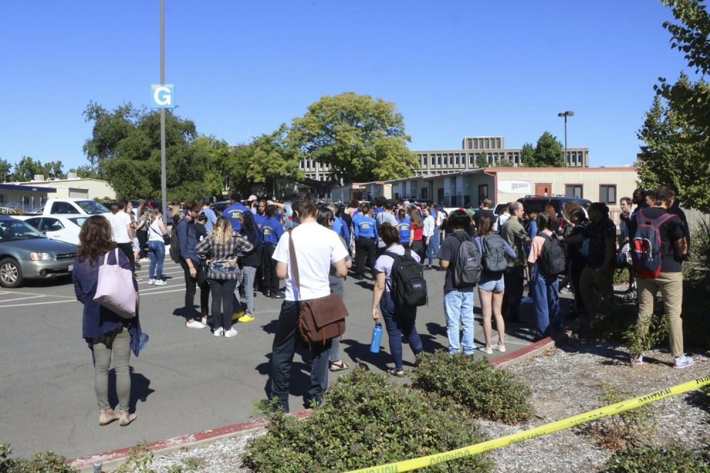 Students and staff wait to resume class in Lot G at American River College during a routine fire drill on Sept. 24, 2019. (Photo by Thomas Cathey)