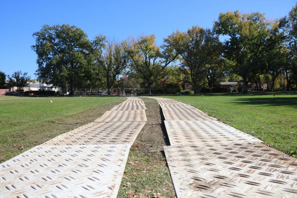 A makeshift path cutting through the grass in front of the campus is being used to get vehicles on and off the construction site on Oct. 29, 2019. (Photo by Jack Harris)