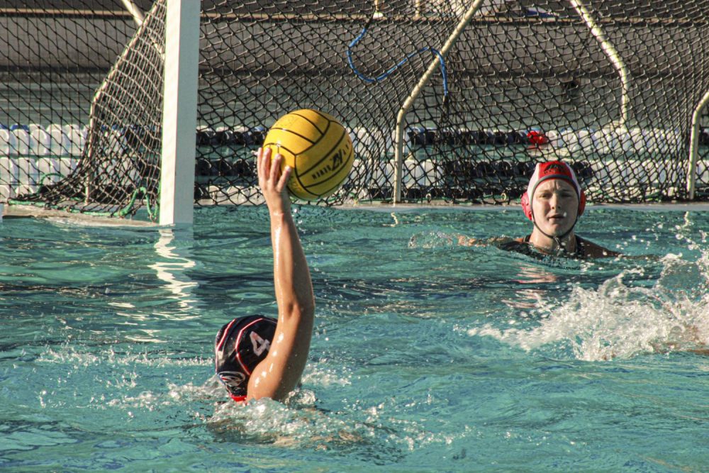 Elizabeth Fomine no. 4 is taking a shot against the San Joaquin Mustangs at the American River College pool on Oct. 9, 2019. (Photo by Bram Martinez)