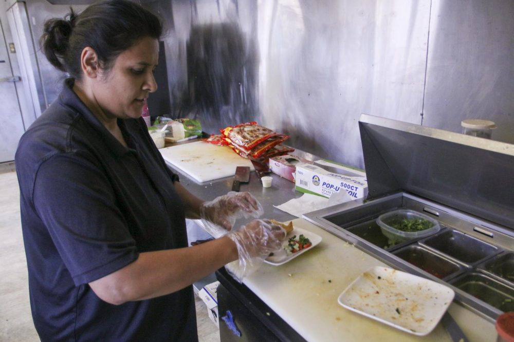 Aqsa Saeed prepares a samosa at Tandoori Bites located in the Portable Village at American River College on Oct. 8, 2019. (Photo by Jack Harris)