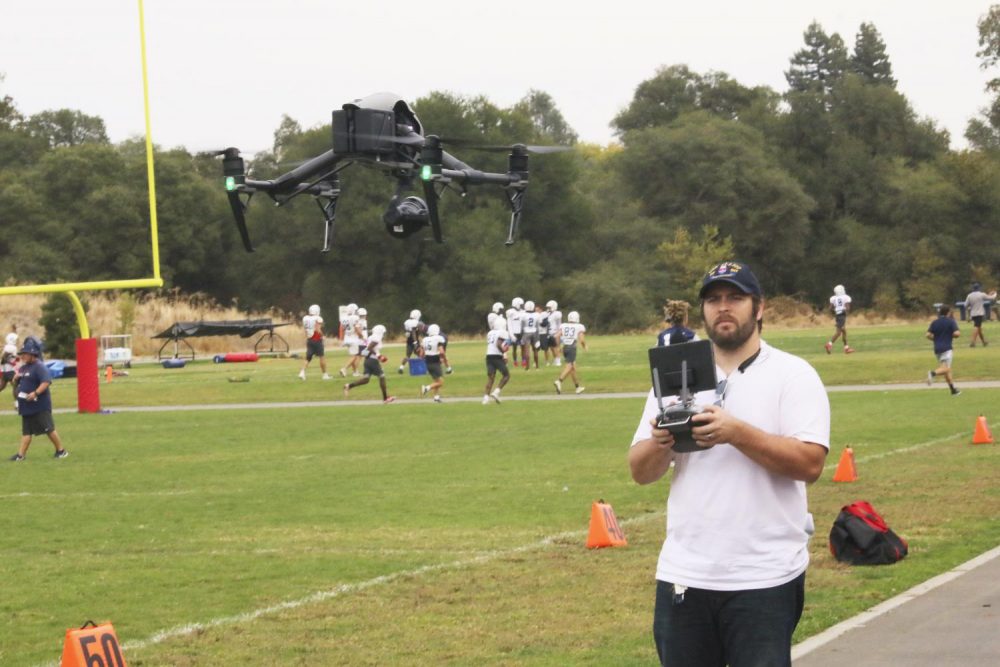 Dan Reid launches a drone to film a few periods of football practice at American River College on Oct. 16, 2019. (Photo by Jack Harris)