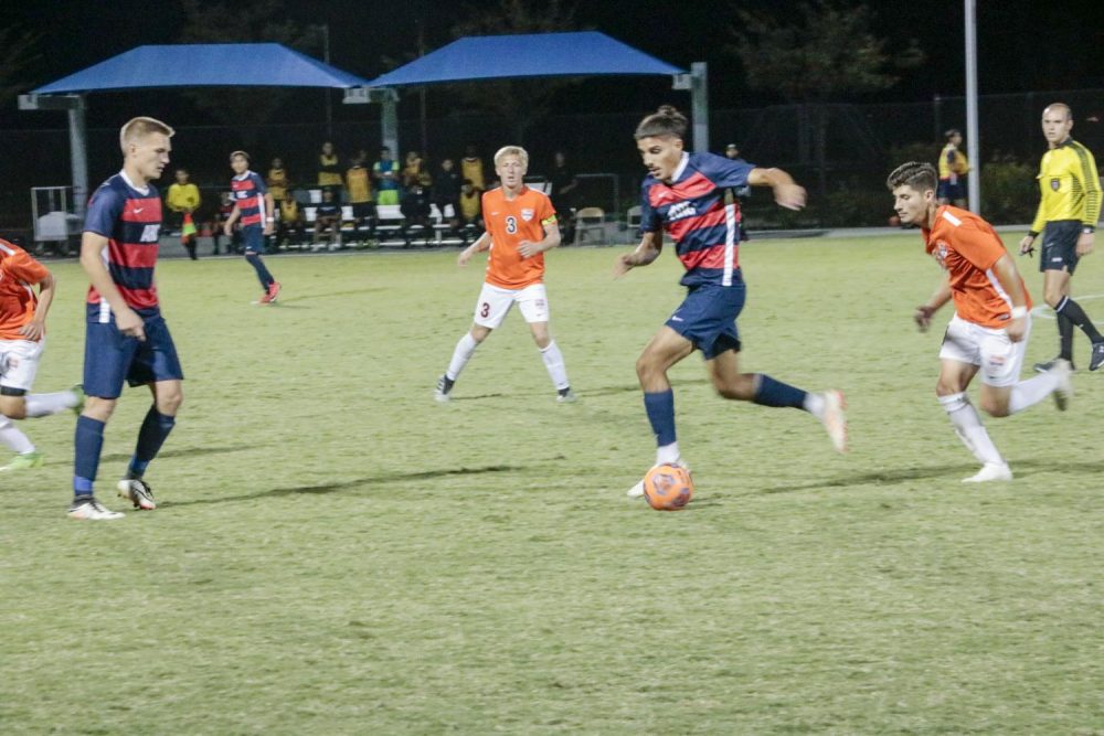 American River College defender Noel Hernandez passes through the Cosumnes River College defense , during a game at ARC on Sept. 27 , 2019. ARC won the game 2-0 (Photo by Josh Ghiorso)