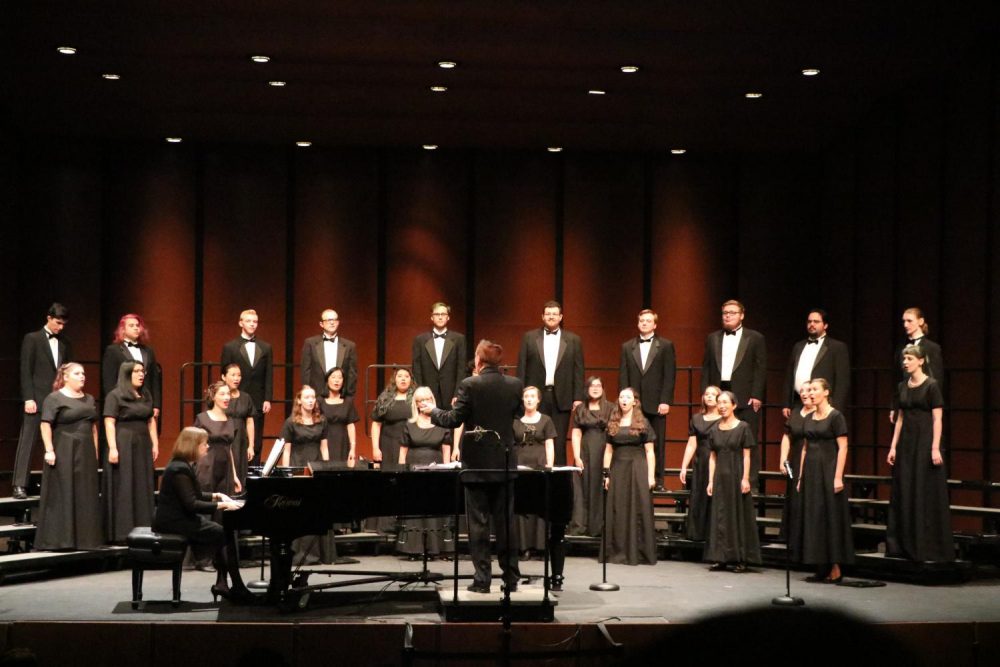 Ralph Hughes conducts the American River College Concert Choir with Heidi Van Regenmorter accompanying for fall the Choral Invitational Concert at the ARC Main theatre on Nov. 5, 2019. (Photo by Bram Martinez)