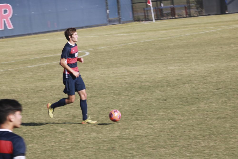 Defensive player Tyler Bevers keeps pace with the ball against the Santa Rosa Bear Cubs at the American River College soccer stadium on Nov. 1, 2019. (Photo by Bram Martinez)