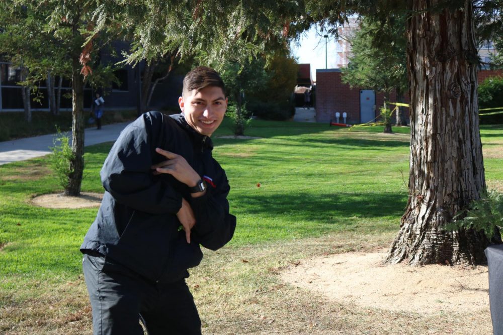 Business administration major and California Family Fitness recruiter Kain Gurrola poses for a picture while taking a break from his booth next to the Learning Resource Center at American River College on Nov 25, 2019. (Photo By Marquala Brown)