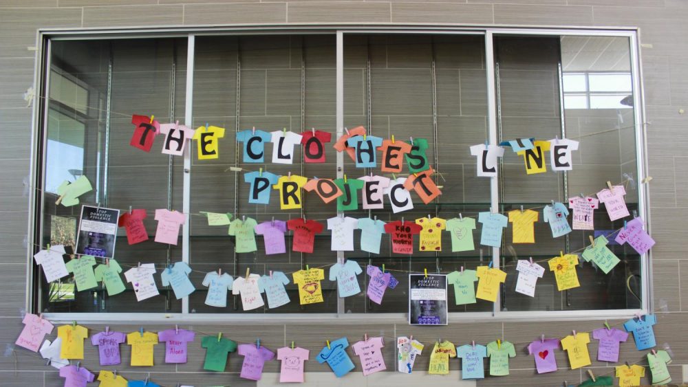 In an attempt to tackle domestic violence and highlight their resources to students, WEAVE’S Clothesline Project hangs in the Student Center at American River College on Nov. 7, 2019. (Photo by Ariel Caspar) 