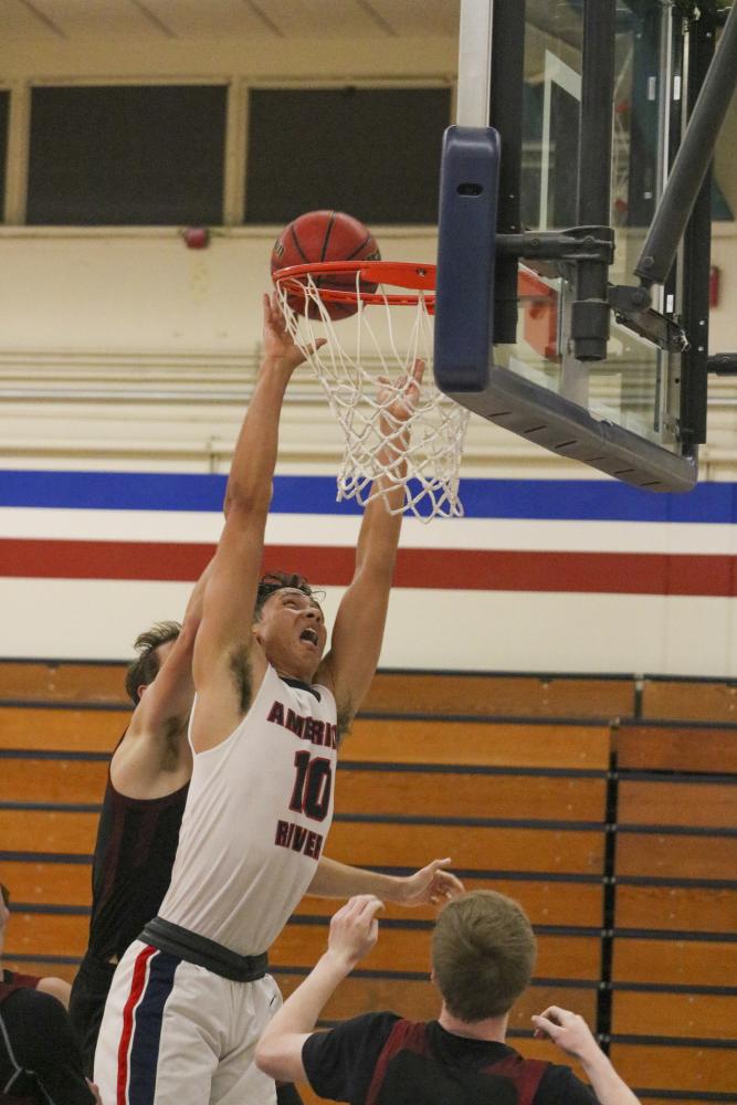 American River College forward Chris Cagle attempts a dunk in a home game against the Redwoods College basketball team on Nov. 7, 2019. (Photo by Colin Bartley)