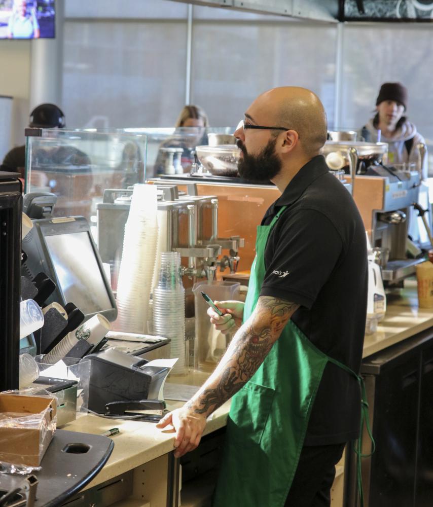 Alfonso Gonzales assists a customer at Starbucks in the Student Center at American River College on Jan. 30, 2020. (Photo by Haven Bishop)