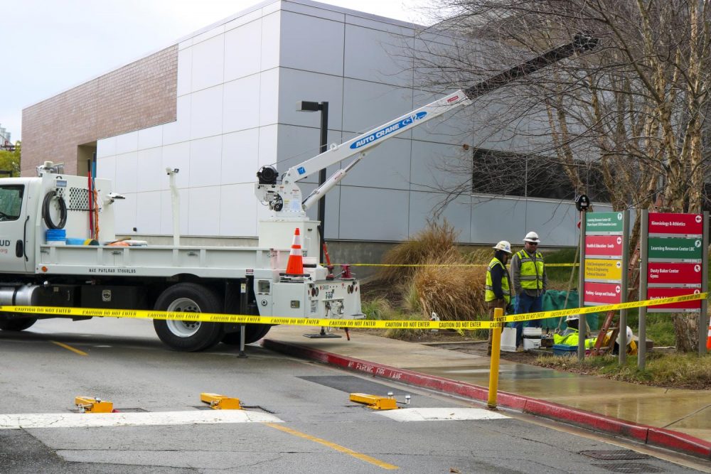SMUD repair trucks close off the road by the American River College main gymnasium on Jan. 28, 2020. (Photo by Colin Bartley)