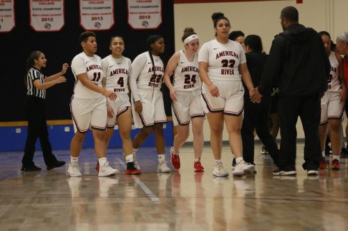 American River Collge women’s basketball team congratulates Jordyn Hilliard after a made basket against San Joaquin Delta College on February 11, 2020. (Photo by Heather Amberson)