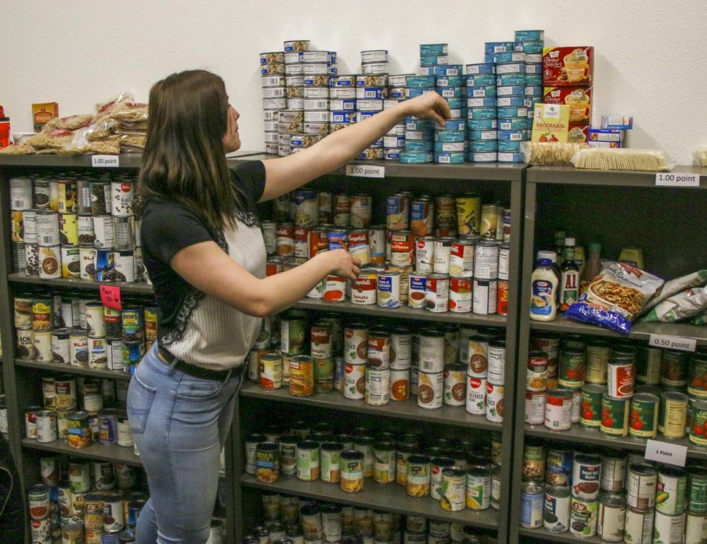 Ana Radu, Student Support Specialist of the Beaver Food Pantry, manages inventory of canned goods at American River College on March 2, 2020. (Photo by Clifton Bullock) 