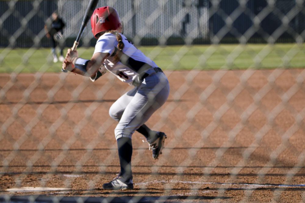 Ciera Pyle about to hit, which leads her to a full run against the Folsom Lake Falcons on Feb. 25 at the softball stadium at American River College.  (Photo by Bram Martinez)