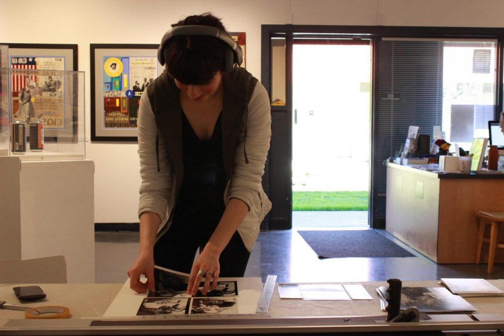 Studio Art major, Diana Ormanzhi is at a table in the Kaneko Art gallery on March 10, 2020, preparing silver gelatin mattering photos to be posted. (Photo by Marquala Brown)